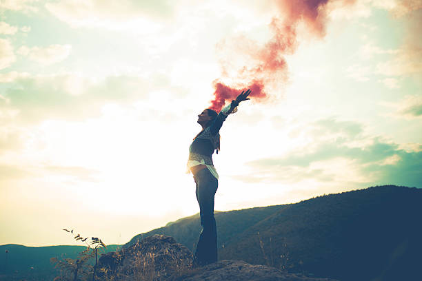 istock Woman standing on a cliff and holds the torch 638458612