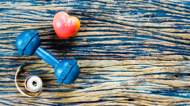 istock dumbbell and measuring tape and red heart 638459872