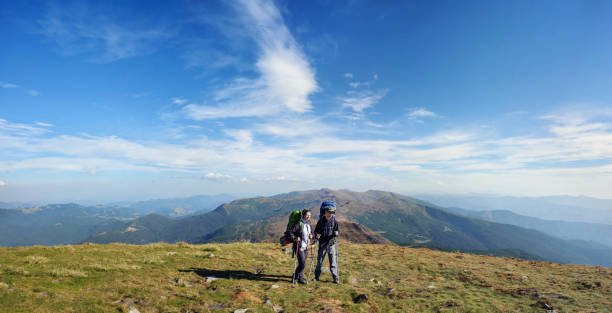 istock Couple hikers in the Carpathians mountains with backpacks 638460852