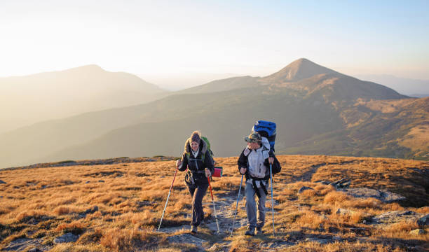 istock Couple hikers in the Carpathians mountains with backpacks 638461138