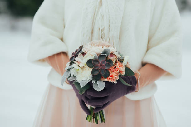 istock bride with a bouquet on the winter background 638461244