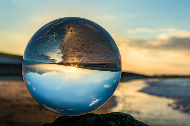 istock Clear glass sphere at the beach during sunset 638461796