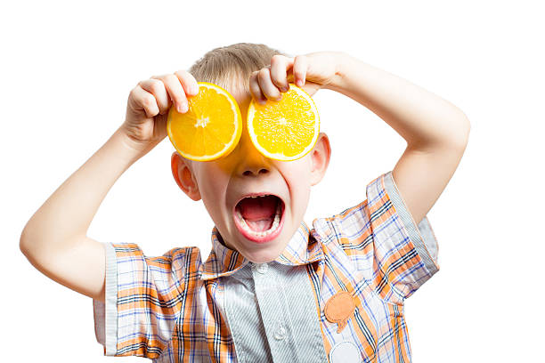 istock Happy funny boy with fresh oranges. 638461958