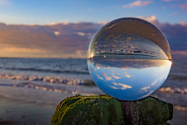 istock Clear glass sphere at the beach during sunset 638462590
