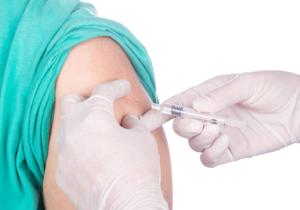 istock nurse with syringe giving a vaccine for a patient 638462700