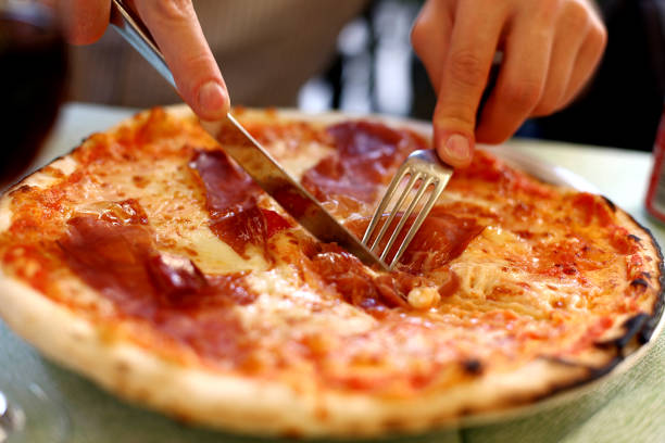 istock Man cuts the Italian pizza with a knife. 638466508