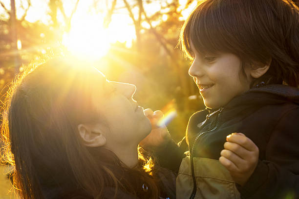 istock Mother and son in beautiful sunset. 638472732