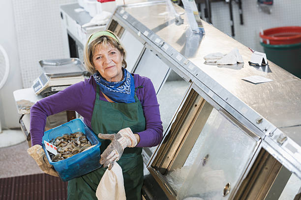 istock Senior woman working in fish market 638480206
