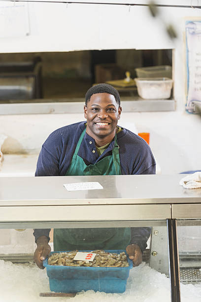 istock Black man working in seafood market 638480288
