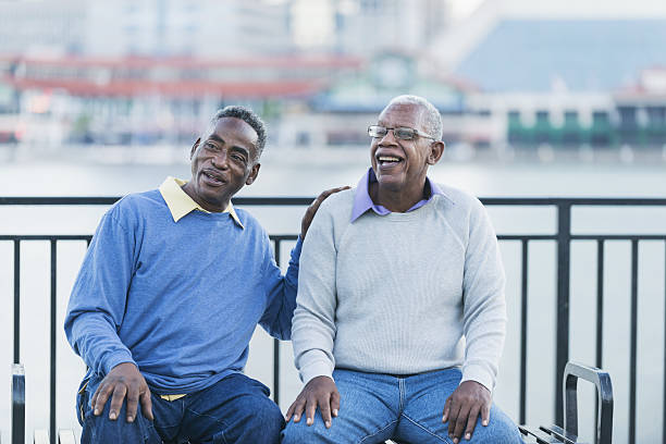 istock Two senior African American men on bench by waterfront 638480384