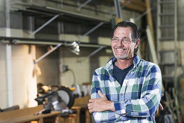 istock Mature man standing in factory workshop 638482110