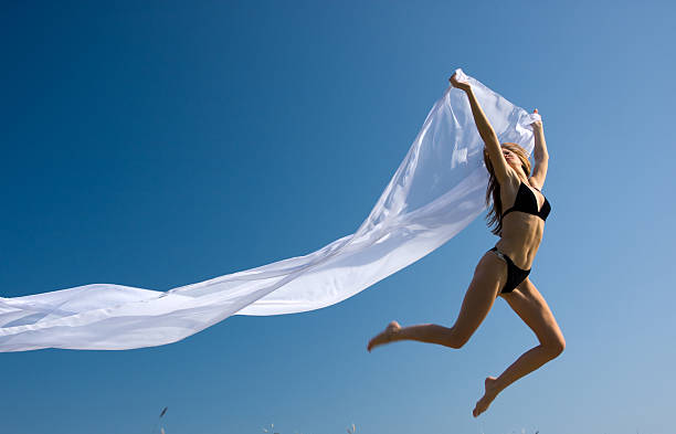 istock woman with white material and nature 638482158