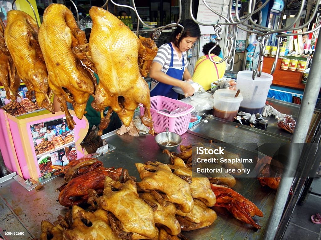 Woman monger Suphan Buri,THailand-June 1,2010:Woman monger is sales the Steamed duck in her shop on June 1,2010 in samchuk market at Suphan Buri,THailand  Adult Stock Photo