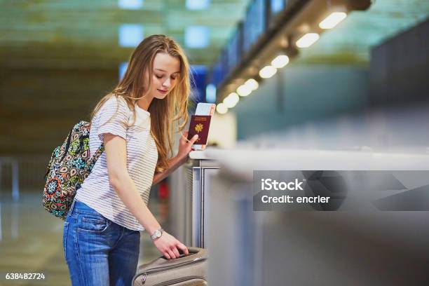 Traveler With Backpack In International Airport At Checkin Counter Stock Photo - Download Image Now