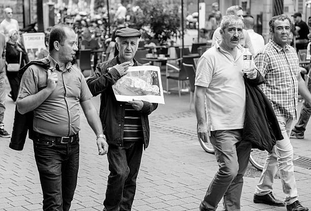 Strasbourg, France - September 12, 2015: Senior men of Kurdish community wave flags and banners of convicted Kurdistan Worker's Party (PKK) leader Abdullah Ocalan during a demonstration calling for Ocalan's release in Strasbourg