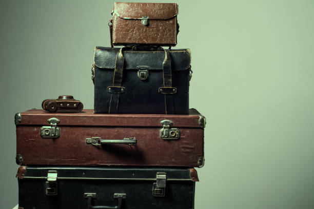 istock Background stack of old shabby suitcases and camera 638486180