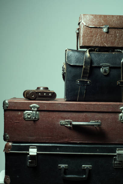 istock Background stack of old shabby suitcases and camera 638486226