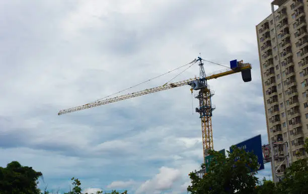Photo of crane and  building photo taken in Jakarta Indonesia