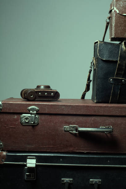 istock Background stack of old shabby suitcases and the camera 638486264