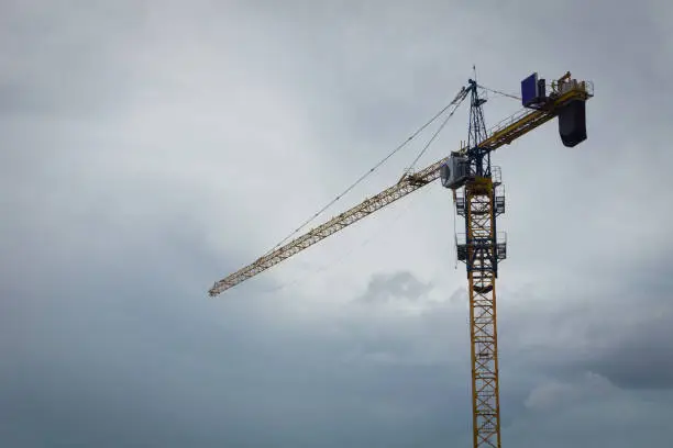 Photo of crane in cloudy sky background photo taken in Jakarta indonesia