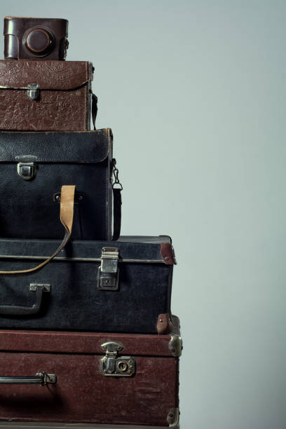 istock Background stack of old shabby suitcases and camera 638486414