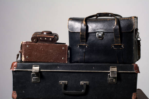 istock Stack of old shabby suitcase with a camera in bag 638486496