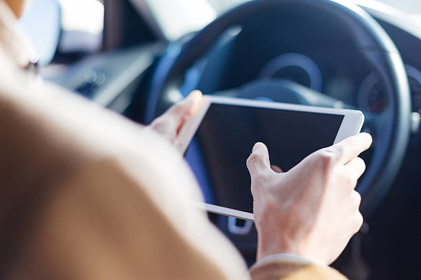 istock young asian man  hold tablet in car 638487574