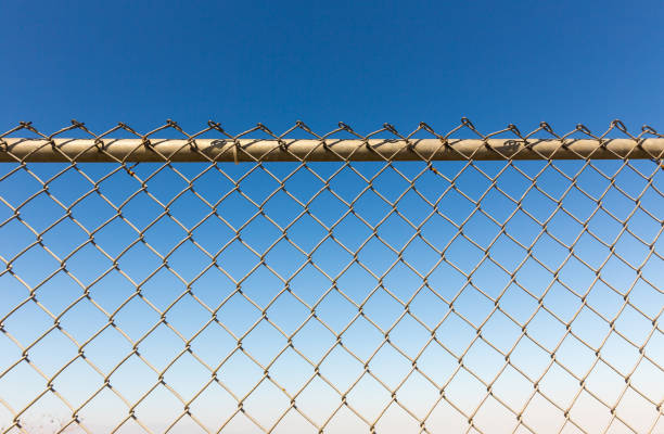 istock Rusty fence rabitz on the background of sky. 638488700