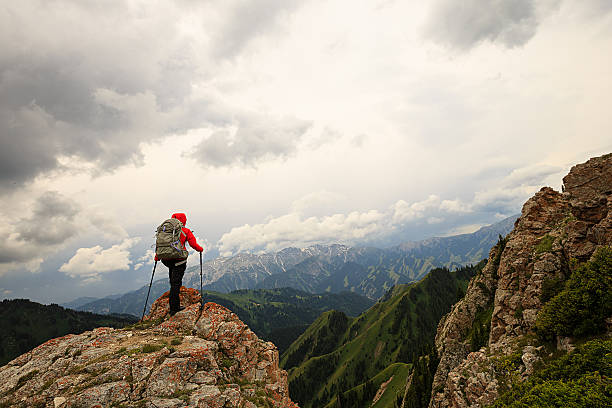 successful woman backpacker enjoy the view on mountain peak