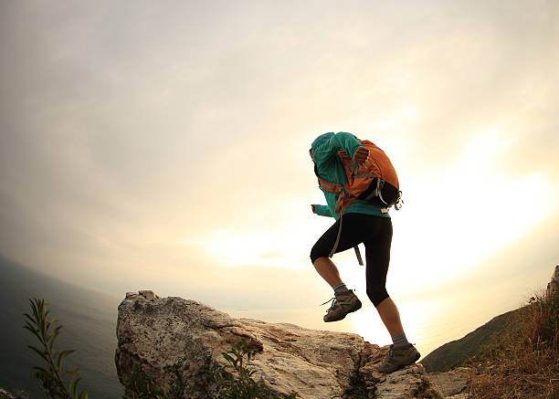 istock successful hiker running on seaside mountain peak 638490460