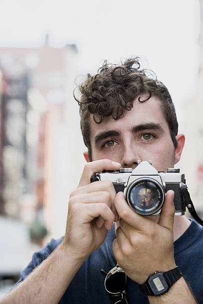 istock Young Belgian man taking photograph in downtown city 638490954