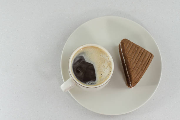 cup of coffee slice of chocolate cake on white background - latté hot chocolate hot drink indulgence imagens e fotografias de stock