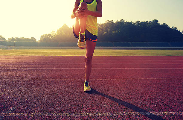 istock Young woman runner stretching legs before run 638495184