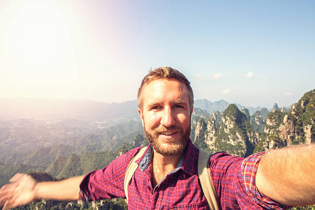 istock Young man hiking takes selfie portrait 638495192