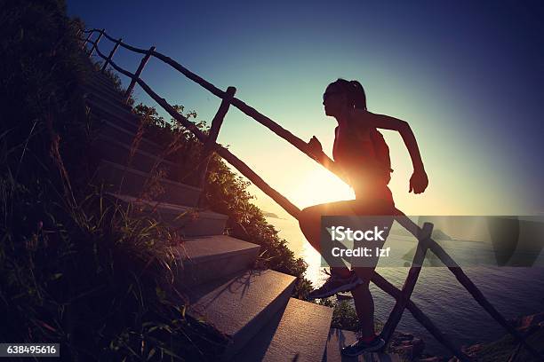 Young Fitness Woman Trail Runner Running Up On Mountain Stairs Stock Photo - Download Image Now