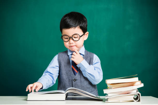 istock Little boy sitting at table and reading 638495952