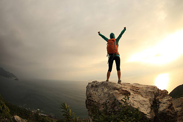 istock successful hiker hiking on seaside mountain peak 638496126