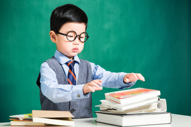 istock Little boy sitting at table and reading 638497386