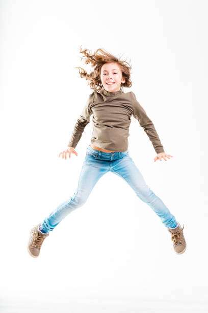 istock jumping girl isolated on white 638500386