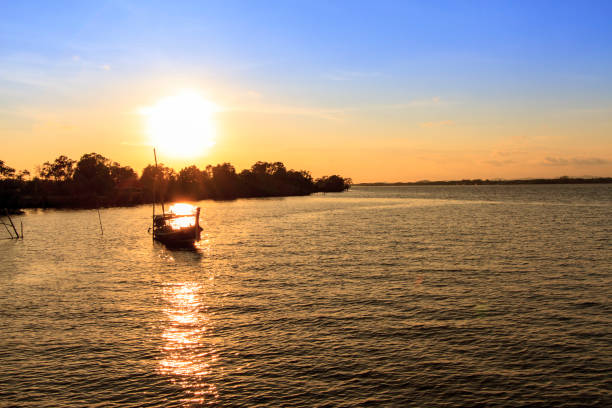 istock Sunset on the beach with fishing boat 638500556