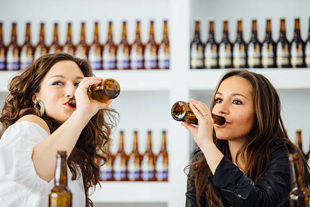 istock Two women drinking beer from bottles 638503984