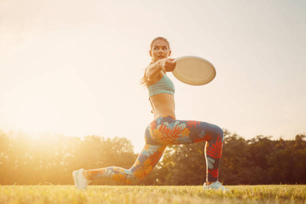 istock Young athletic girl playing with flying disc, ultimate 638504670