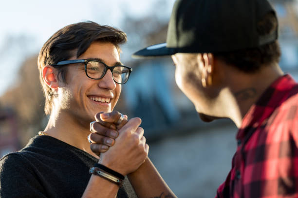 istock good friends joking about their secret handshake 638505962
