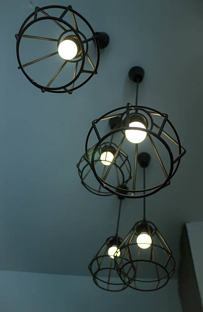 istock Vintage hanging light bulb over grey room 638506548