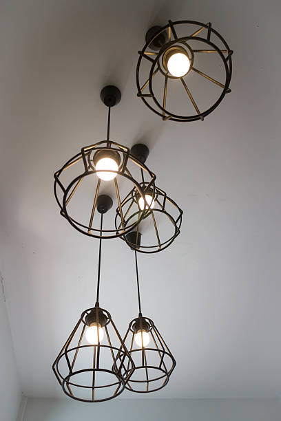 istock Vintage hanging light bulb over grey room 638506558