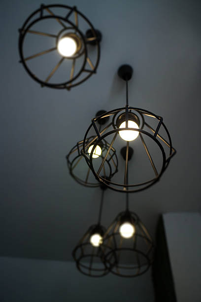istock Vintage hanging light bulb over grey room 638506588