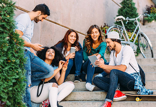 istock Friends browsing the net outdoors 638508358