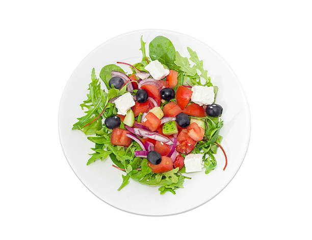 istock Greek salad in a white dish on a light background 638511448