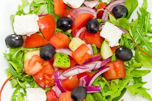istock Greek salad in a white dish closeup 638511508