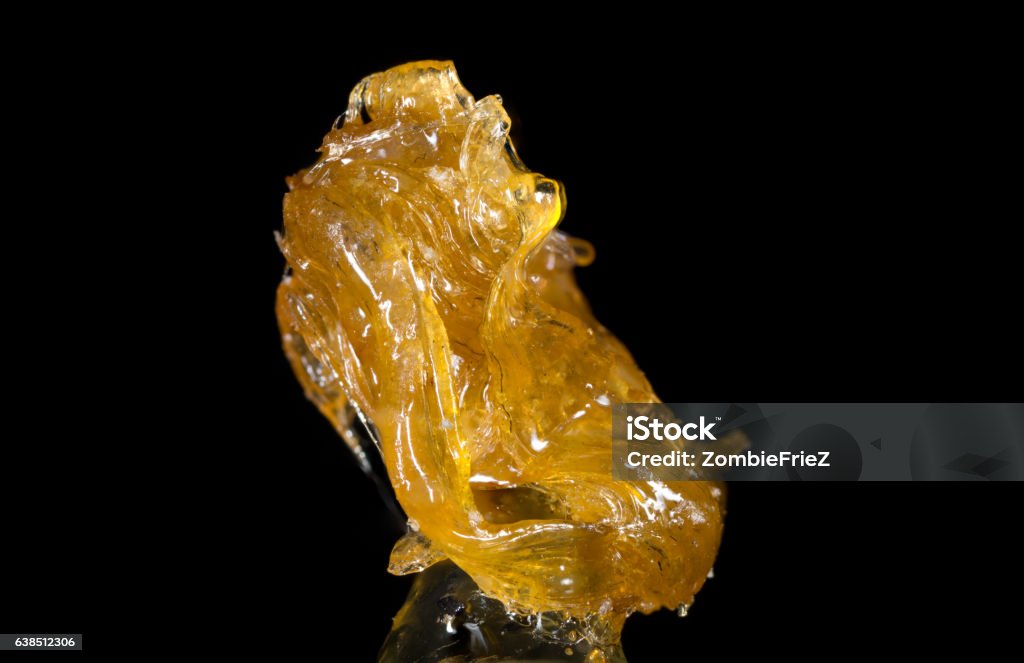 Alien Rock C Cannabis Shatter Hash A close up shot of a dab of Cannabis Shatter Hash.  Cannabis Plant Stock Photo